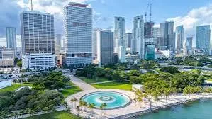 Aerial view of a downtown Miami waterfront park beside high-rise office towers